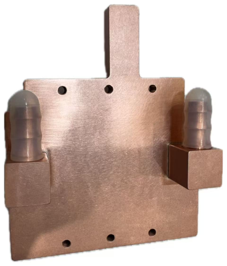 AMX copper cold-plate example — two hose-barb ports and mounting features; heat-transfer performance requires the specific test setup.