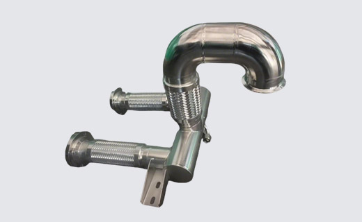 Deya formed metal system-pipe module with a return bend, flexible branches and a mounting lug; drawing-defined reference.